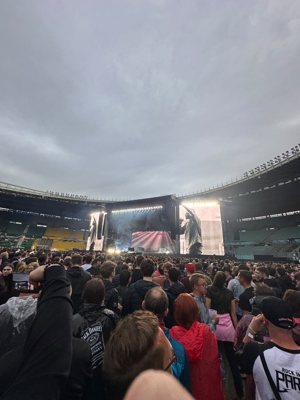Menschenmenge in einem überdachten Stadion bei einem Linkin Park Konzert mit großer Bühne und Bildschirmen im Hintergrund