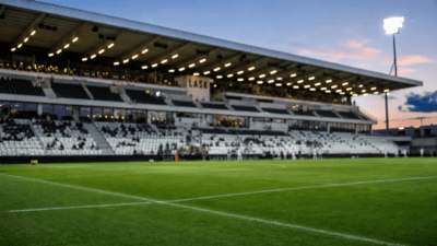 Fußballstadion von LASK im Abendlicht mit grünem Rasen und beleuchteter Tribüne