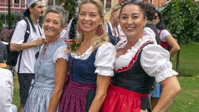 Drei Frauen in traditionellen Dirndln lächeln in die Kamera beim Kirchtag.