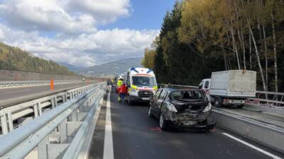 Beschädigter Pkw und Rettungswagen auf einer Autobahnbaustelle