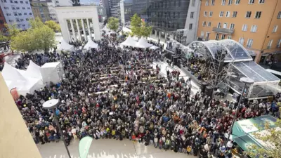 Besucher versammeln sich beim Tag der offenen Tür in Innsbruck auf einem Platz vor Zelten und einer Bühne.