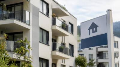 Modernes Wohngebäude neben einem Schild mit Haussymbol